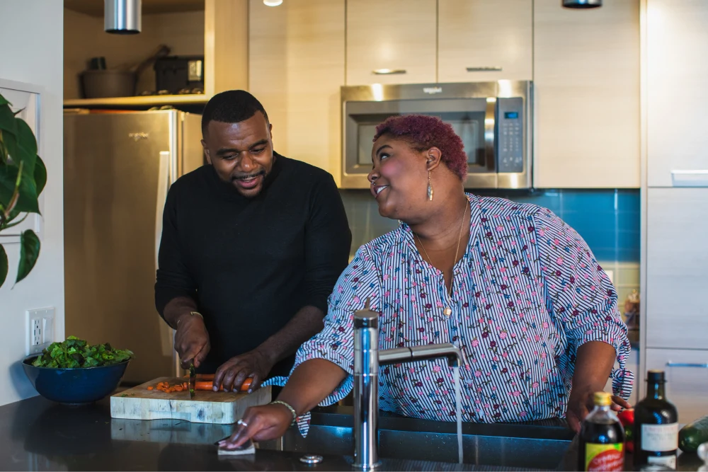 man and woman cooking in the kitchen together