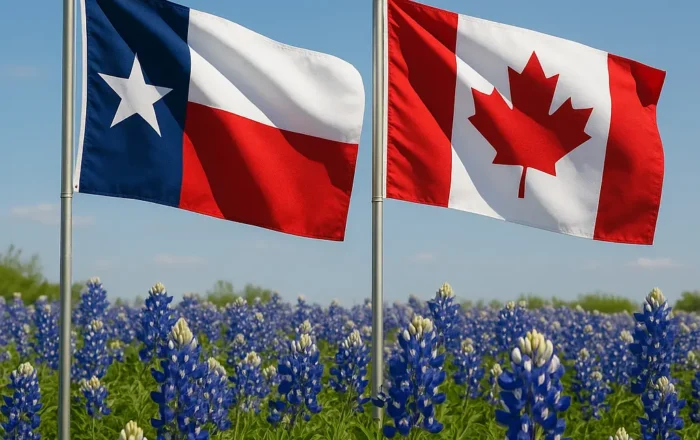 Texas flag and Canadian flag in front of a field of bluebonnets